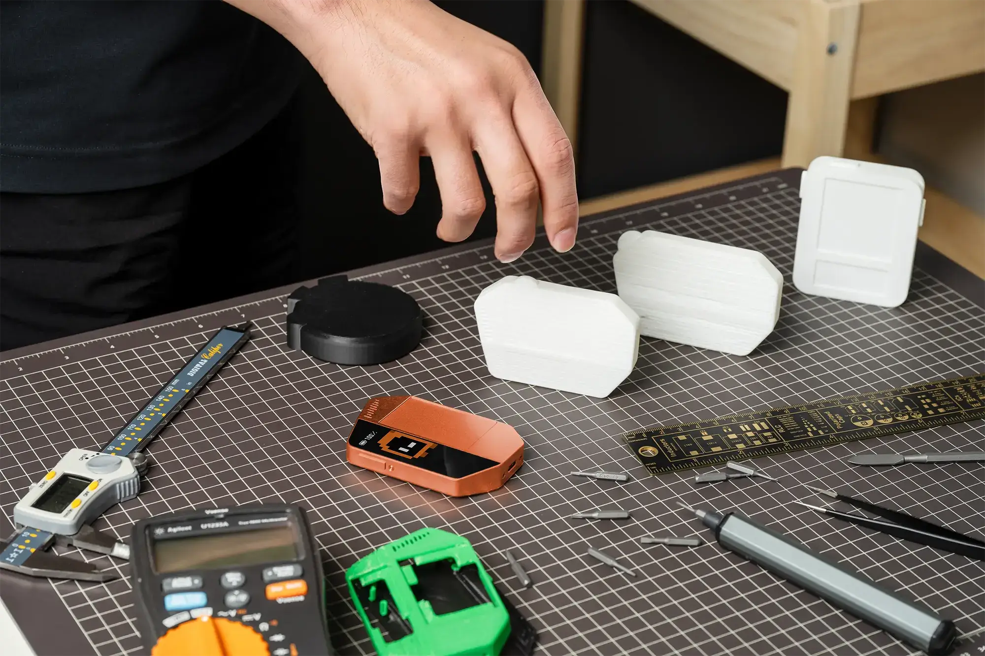 WhisPrompt prototypes and engineering tools arranged on a workbench